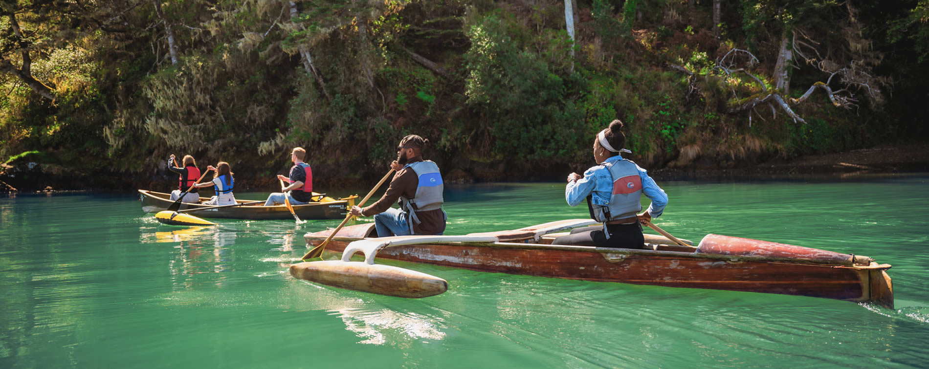 outrigger canoes on big river